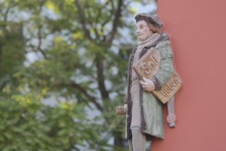 Historical merchant from the 16th century with book and inscription Soll Haben, created in 1933,