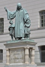 Monument to theologian, pedagogue and poet, August Hermann Francke, man with two children, protect,