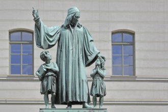 Monument to theologian, pedagogue and poet, August Hermann Francke, man with two children, protect,