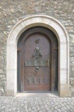 Door with fittings and entrance to the cathedral, front door with decorations and door knocker