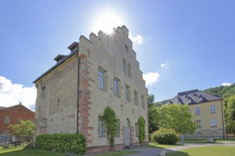 Gothic house with stepped gable in the backlight of the former Cistercian abbey and today's
