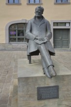 Monument to philosopher Friedrich Nietzsche, bronze sculpture, modern art, sitting on chair with