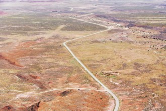 Winding roadway cutting through Valley of the Gods, Utah, USA