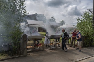 Heavy smoke at the sausage grill stations at the Backofenfest, Kleingeschaidt, Middle Franconia,