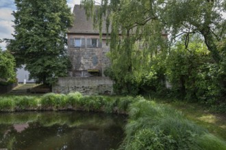 Historic farmhouse by a village pond, Kleingeschaidt, Middle Franconia, Bavaria, Germany