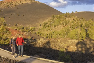 Couple walking on pathway, Sunset Crater Volcano National Monument, Flagstaff, Arizona, USA