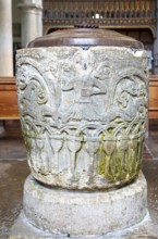 Historic baptismal font inside village parish church of Saint James, Avebury, Wiltshire, England,