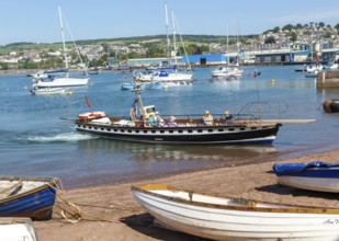 Shaldon ferry arriving, small boats in harbour at Back Beach, Teignmouth, south Devon, England, UK