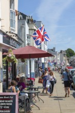 Union Jack flags on shops in street of historic buildings, The Strand, Dawlish, south Devon,