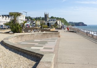 Seafront promenade view east towards St Michael's church, Teignmouth, south Devon, England, UK
