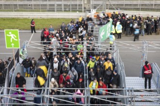 Festival visitors stream via separate entrances to the front breakwaters in front of the Utopia