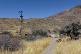 Picnic table and old abandoned windmill along the Bar Canyon Trail in Organ Mountains - Desert