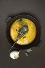 Cracked egg in a pan, hen's egg and eggshells