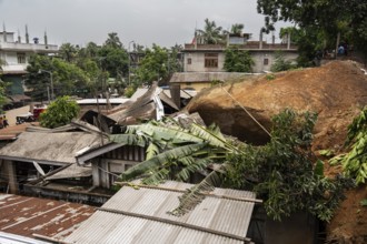 Damaged houses after a major landslide, triggered by a heavy downpour, in Guwahati, India, on June