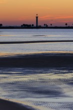 Sunrise silhouette of Broadwater Beach Marina Light at Biloxi, Mississippi, USA