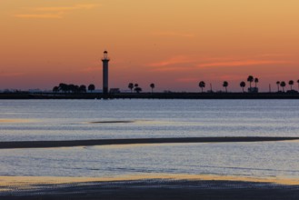 Sunrise silhouette of Broadwater Beach Marina Light at Biloxi, Mississippi, USA