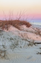 Colourful evening sky shines on sand dunes of Fort Morgan Fishing Beach at Fort Morgan, Alabama,
