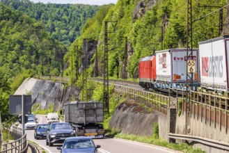 Goods train on the winding railway line of the Geislinger Steige, next to the federal road 10.