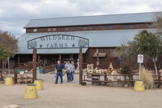 Family leaving the Wildseed Farms nursery in Fredericksburg, Texas, USA