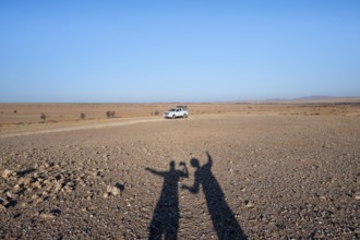 Shadow of two people, holiday, off-road car on a sandy track, Brandberg, Damaraland, Namibia