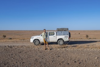 Tourist with off-road car on a sandy track, Brandberg, Damaraland, Namibia