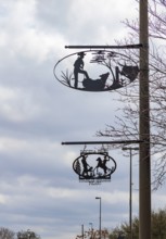 Artistic metal signs showing cowboy life on poles in Bandera, Texas, USA