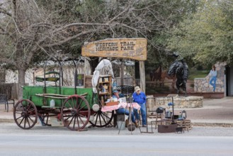 Senior men demonstrating a covered wagon camp site outside the Western Trail Heritage Park in
