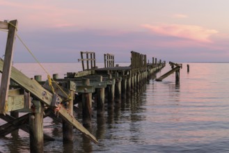 Dilapidated fishing pier damaged from hurricanes in Long Beach, Mississippi, USA