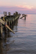 Dilapidated fishing pier damaged from hurricanes in Long Beach, Mississippi, USA