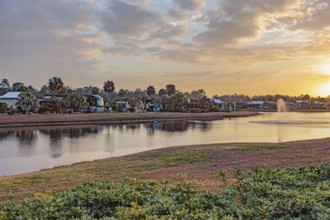 Motorhomes with waterfront lots in RV Resort at sunset in southern Alabama, USA