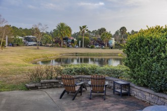 Motorhomes with waterfront lots and patios at RV Resort in southern Alabama, USA