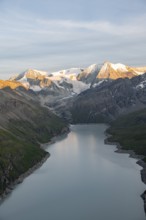 View at the summit of Mont de la Blana, alpenglow at sunset, view of a blue mountain lake, Lac des