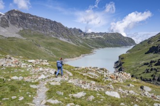 Mountaineer on a hiking trail in an idyllic mountain landscape, Lac des Dix reservoir in the