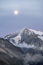 Summit Mont Blanc de Cheilon with glaciers, evening mood, moon stands over mountain peaks at the