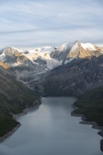 View at the summit of Mont de la Blana, in evening light, view of a blue mountain lake, reservoir