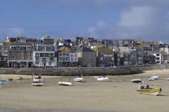 A busy coastal harbour with many boats and a town with densely built houses, St Ives, Cornwall,