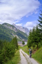 Cyclist on the railway cycle path, at the Rifugio Ospitale, Val Felizon, Cortina d'Ampezzo,