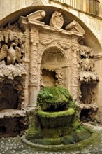 Ornamental fountain from the Renaissance, fountain with moss and artificial dripstone from the