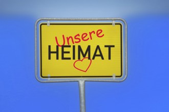 (Photomontage) Town sign with the inscription UNSERE HEIMAT and a heart