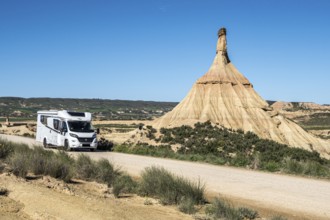 Camper van on gravel road, Castildetierra rock formation, semi-desert, Bardena Blanca area,