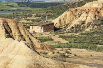 Colorful rock formation, smal hut, semi-desert, Bardena Blanca area, Bardenas Reales Nature Park,