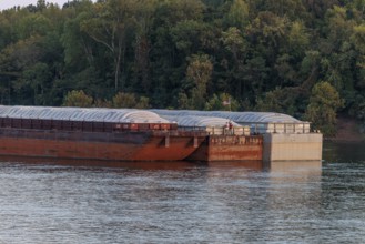 Deck hands place the American flag on a barge being pushed on the Tennessee River near Savannah,