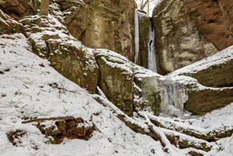 Snow-covered rocks and frozen waterfalls in a wintry landscape, the Drachenschlucht gorge near