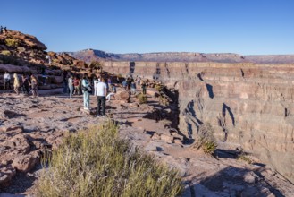 Tourists on the edge of the canyon at Guano Point area of Grand Canyon West near Peach Springs,