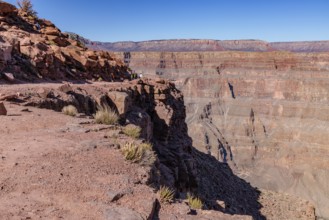 Visitors walk along the canyon rim to the location of the old mining cable structure at Guano Point
