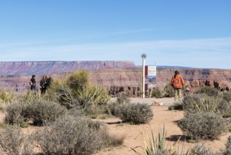 Native American security officer standing by sign with information about Eagle Point observation