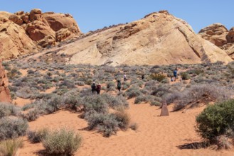Hikers near the trailhead of the Fire Canyon Overlook Trail at Valley of Fire State Park near