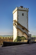 White watchtower with external staircase under a blue sky, Wartburg Castle near Eisenach in