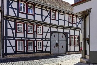 A traditional half-timbered house with a characteristic wooden structure and small windows in a