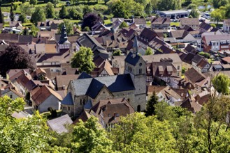 View of a picturesque village with old half-timbered houses and a central church in the